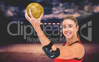 Composite image of female athlete with elbow pad holding handbal