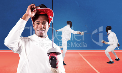 Composite image of portrait of swordsman standing with fencing m