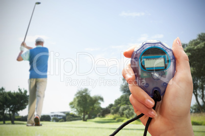 Composite image of close up of woman is holding a stopwatch