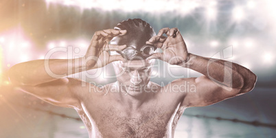 Composite image of swimmer holding swimming goggles