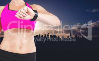 Composite image of female athlete watching her smart watch