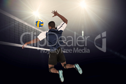 Rear view of sportsman playing volleyball