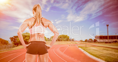 Female athlete posing with hands on hip Female athlete posing with hands on hip