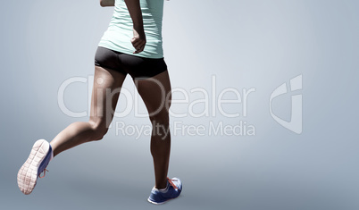 Composite image of rear view of sportswoman running on a white b