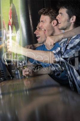 Composite image of friends are watching sport on television
