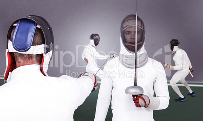 Composite image of man wearing fencing suit practicing with swor