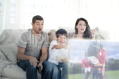 Composite image of happy family watching television