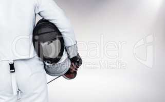 Composite image of rear view of swordsman holding fencing mask a