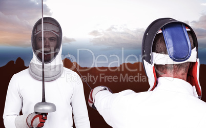 Composite image of man wearing fencing suit practicing with swor