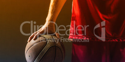 Close up on a basketball held by basketball player