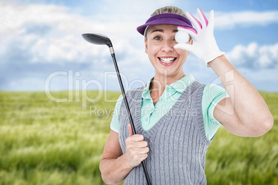 Composite image of pretty blonde playing golf