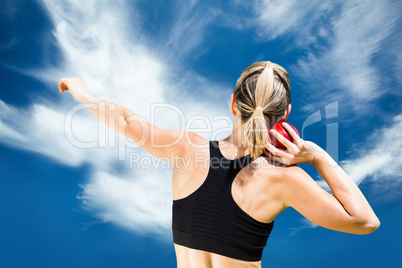 Composite image of rear view of sportswoman is practising shot p