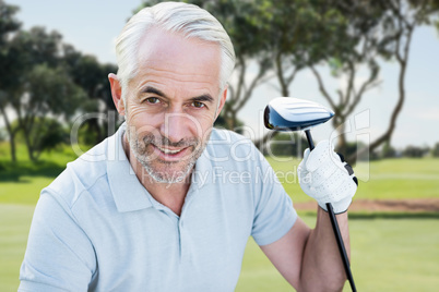 Composite image of man holding a golf club