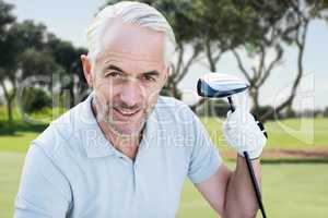 Composite image of man holding a golf club