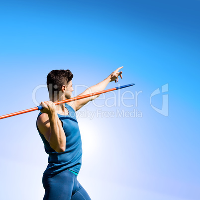 Rear view of sportsman practising javelin throw