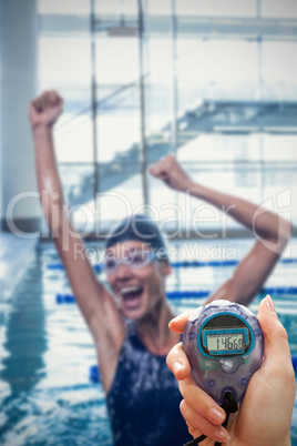 Composite image of close up of a hand holding a timer on a white