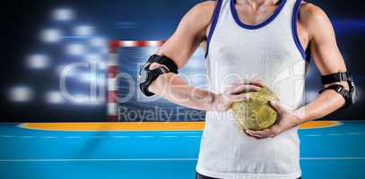 Composite image of mid section of athlete man holding ball