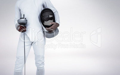 Composite image of swordsman holding fencing mask and sword