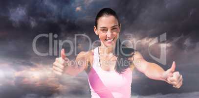 Composite image of portrait of sportswoman is smiling with thumb