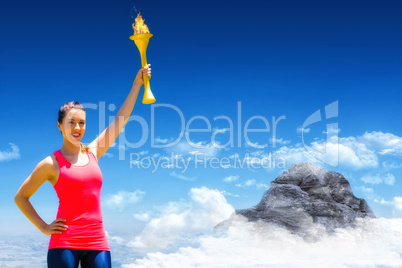 Composite image of sporty woman posing and smiling with olympic