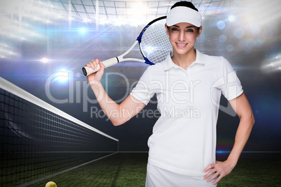 Sportswoman posing with her tennis racket