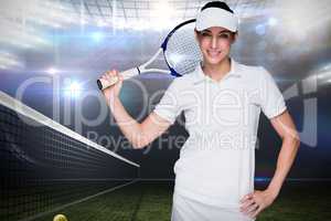 Sportswoman posing with her tennis racket