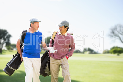 Composite image of men carrying golf equipment