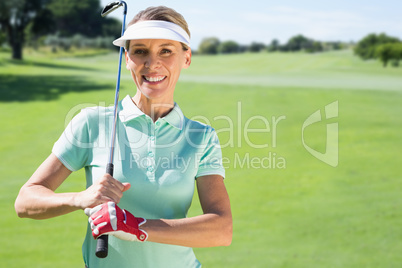 Composite image of woman playing golf