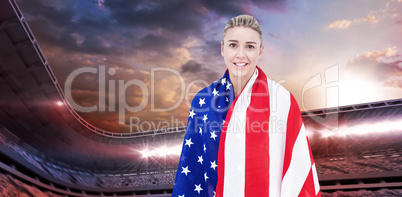 Female athlete with american flag on her shoulders