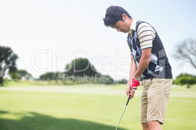 Man playing golf against view of a park