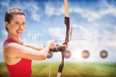 Composite image of portrait of sportswoman is smiling and practising archery