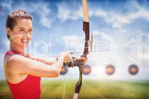 Composite image of portrait of sportswoman is smiling and practising archery