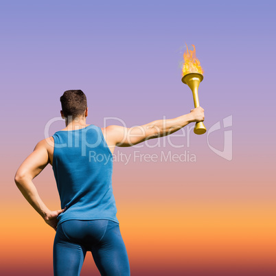 Composite image of rear view of athletic man holding the olympic