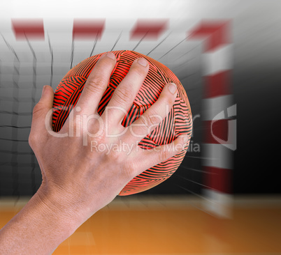 Composite image of sportswoman holding a ball