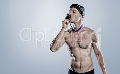 Composite image of swimmer kissing his gold medal