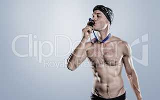 Composite image of swimmer kissing his gold medal