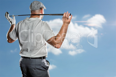 Composite image of rear view of golf player holding a golf club