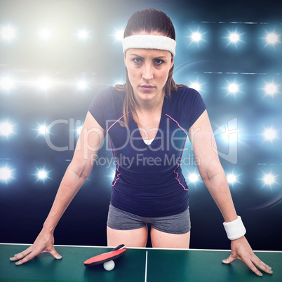 Composite image of angry female athlete leaning on hard table