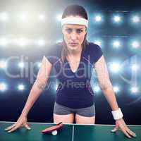 Composite image of angry female athlete leaning on hard table