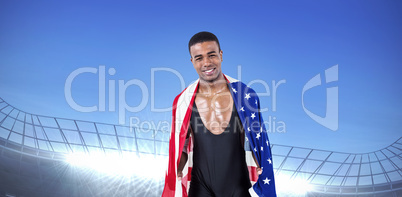 Composite image of athlete with american flag wrapped around his