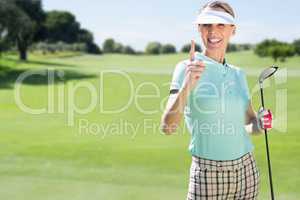 Smiling woman playing golf