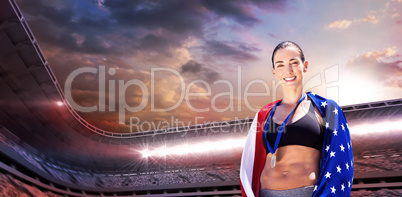 Sporty woman posing and smiling with American flag