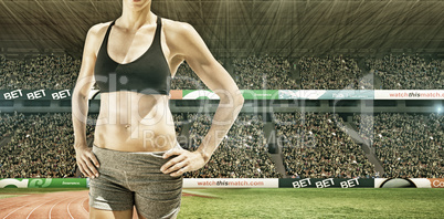 Composite image of sportswoman is posing and smiling