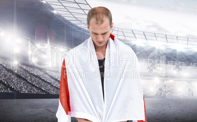 Composite image of athlete with england flag wrapped around his