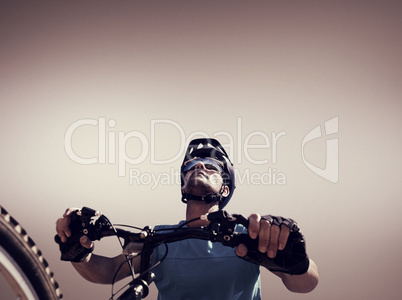 Composite image of man cycling with mountain bike