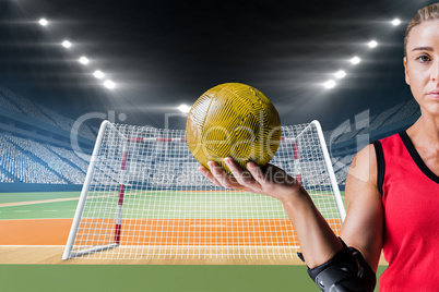 Composite image of female athlete with elbow pad holding handbal