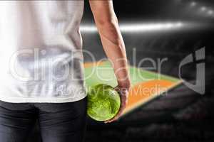 Composite image of mid section of athlete man holding ball