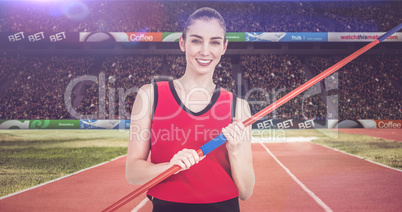 Composite image of female athlete holding a javelin