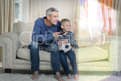Composite image of father and son are watching sport match on te