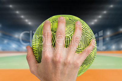 Composite image of sportswoman holding a ball